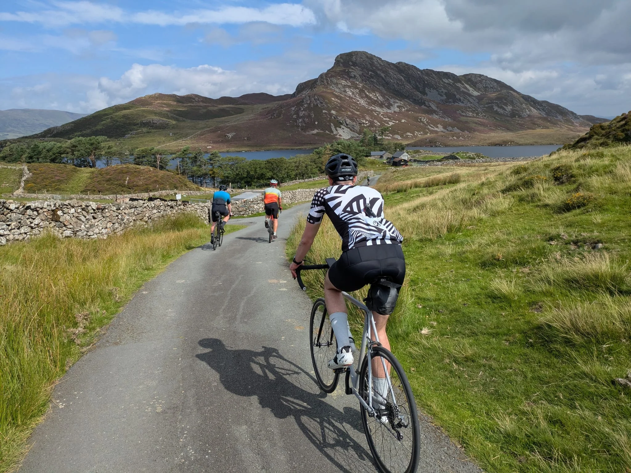 Out Velo riders cycling through the Welsh mountains